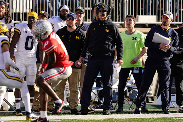 Michigan Wolverines head coach Jim Harbaugh watches from the sideline beside off-field analyst Connor Stalions, right, during the NCAA football game against the Ohio State Buckeyes at Ohio Stadium